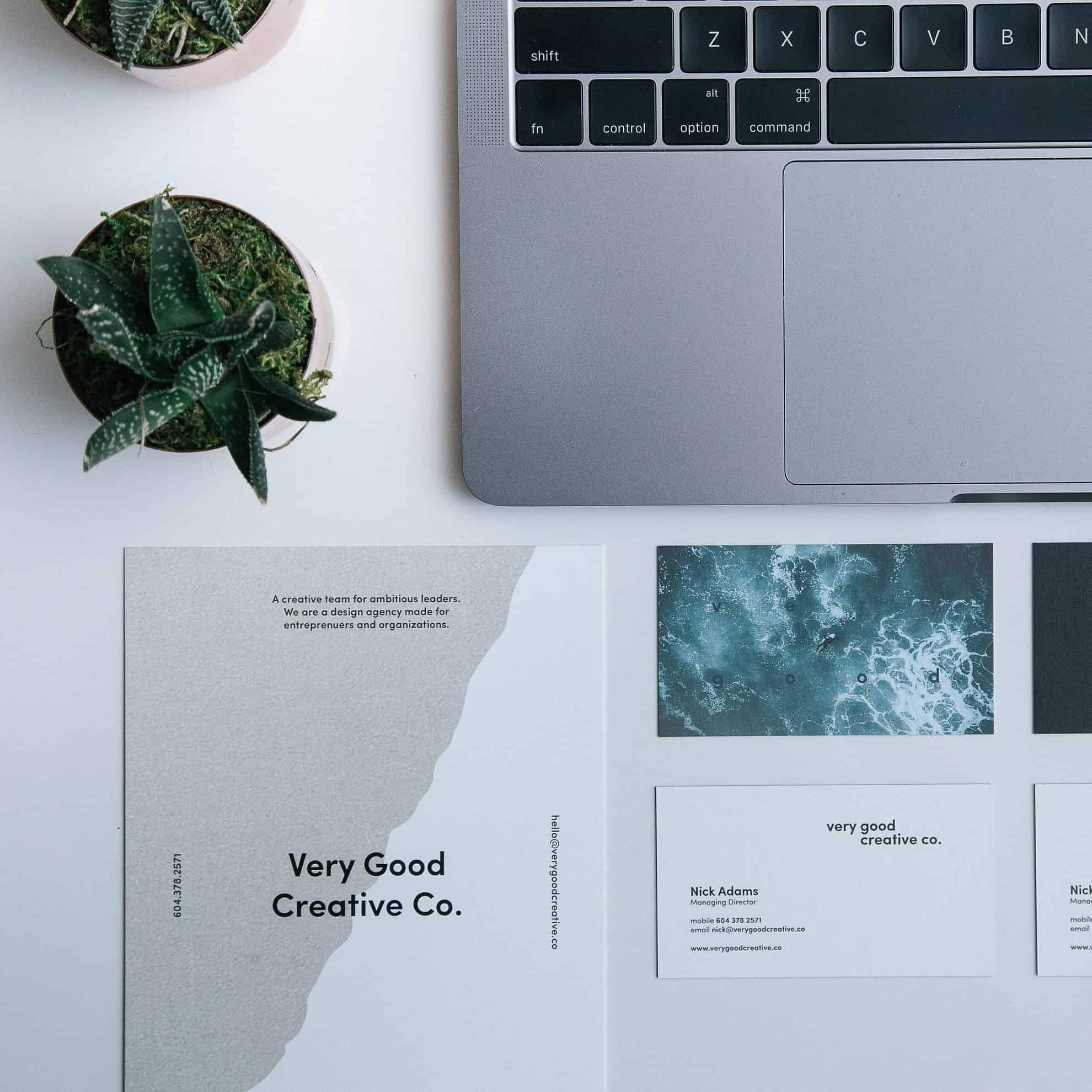 sincere copy business cards and laptop on a white table graphic design