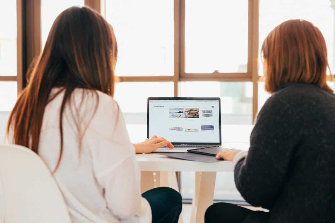 sincere copy copywriting two women looking at laptop